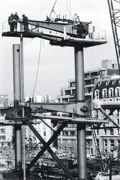 A black and white photo of a building under construction with the number 10 on it
