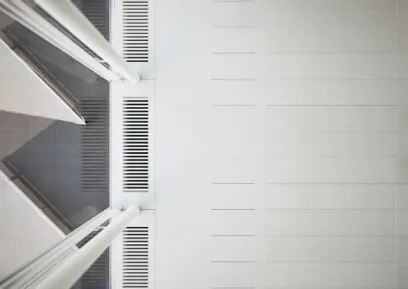 looking up at the ceiling of a room with a ventilation system .