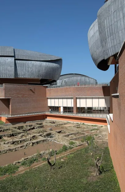 A large building with a lot of windows and a brick wall
