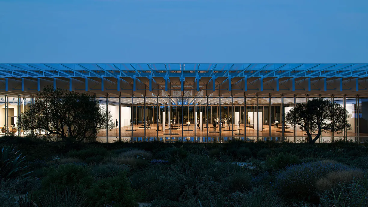 a large building with a lot of windows and trees in front of it .