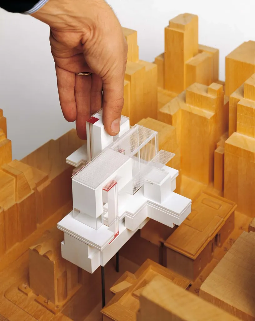 A person is playing with a model of a building