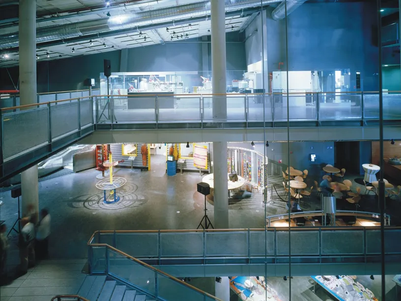 An aerial view of a large building with stairs and tables