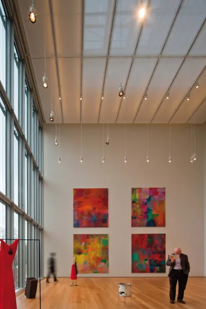 A man taking a picture of a painting in a museum