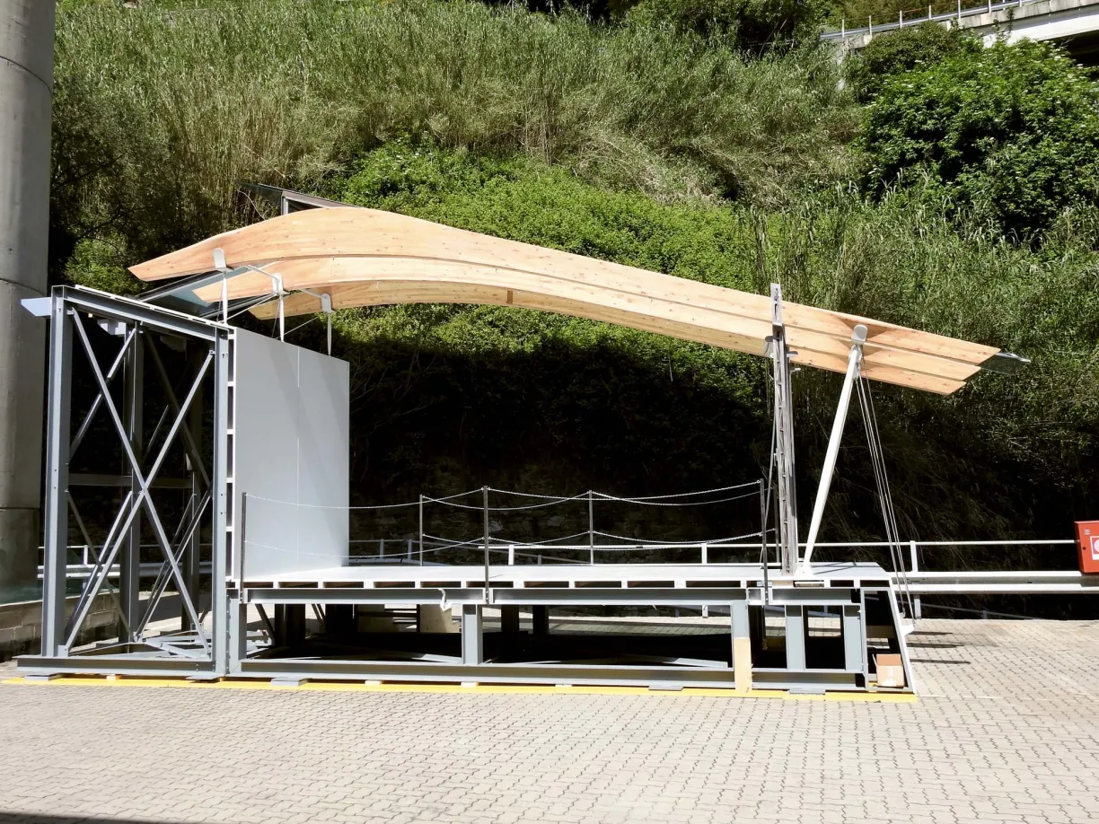 a wooden structure is sitting on top of a brick pavement in a parking lot .