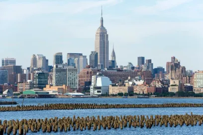 A city skyline with a large body of water in the foreground