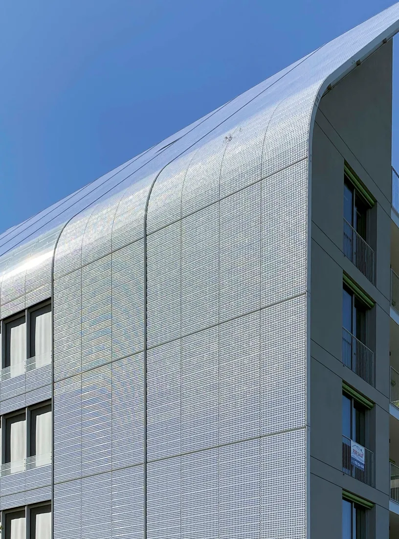 A building with a sign on the balcony that says " for sale "