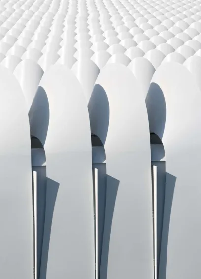 A row of white chairs are lined up in a row