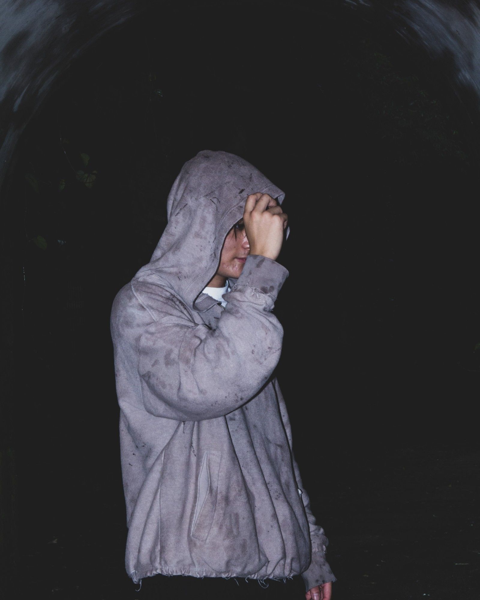 Model pulling the hood down, night