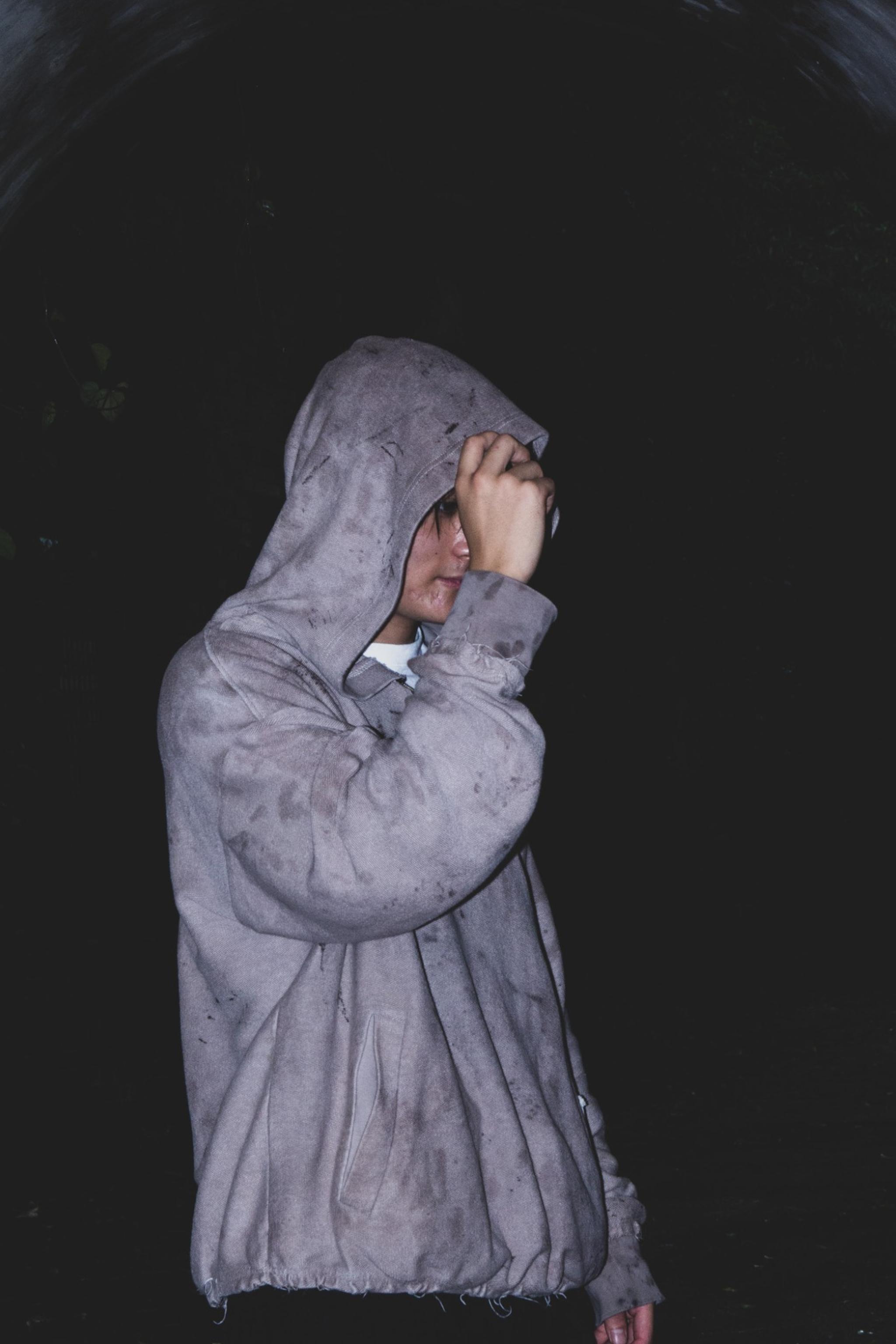 Hood pulled down, at night