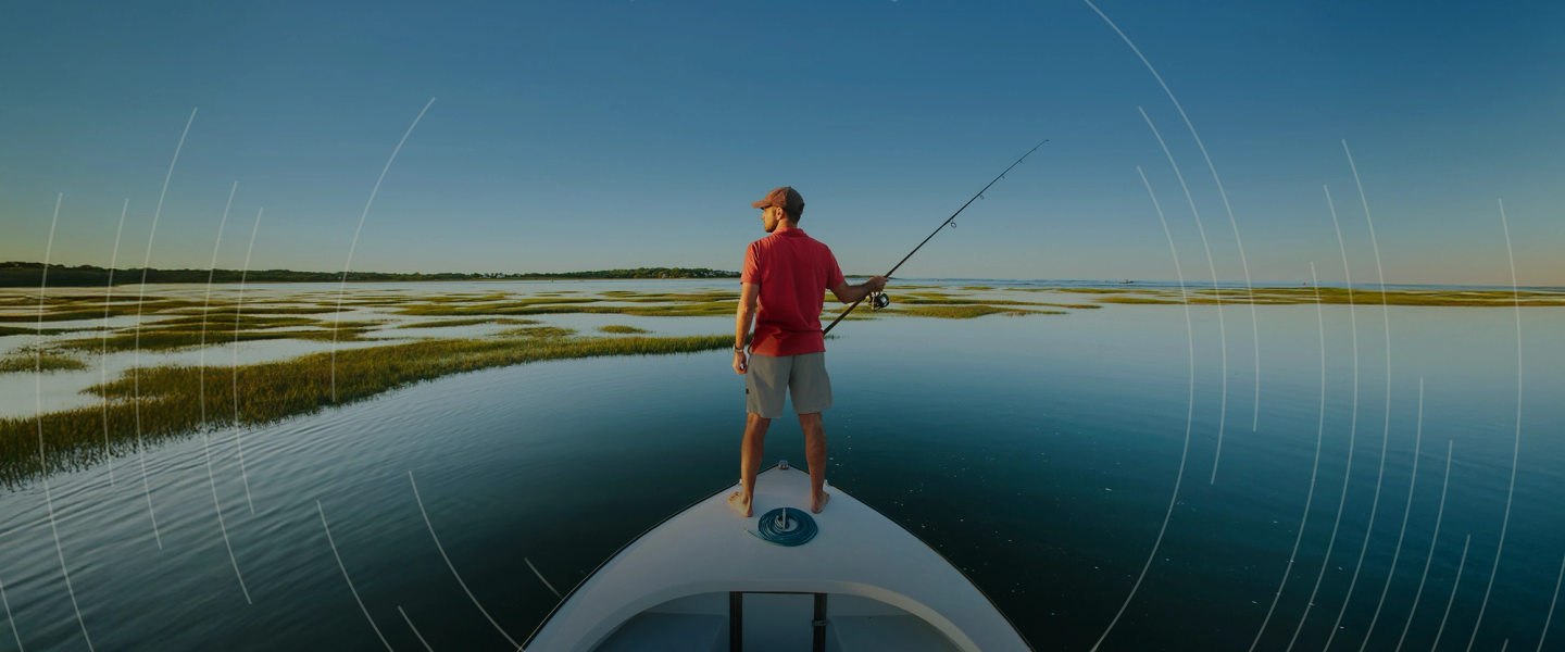 Man in a boat lookin at its left side