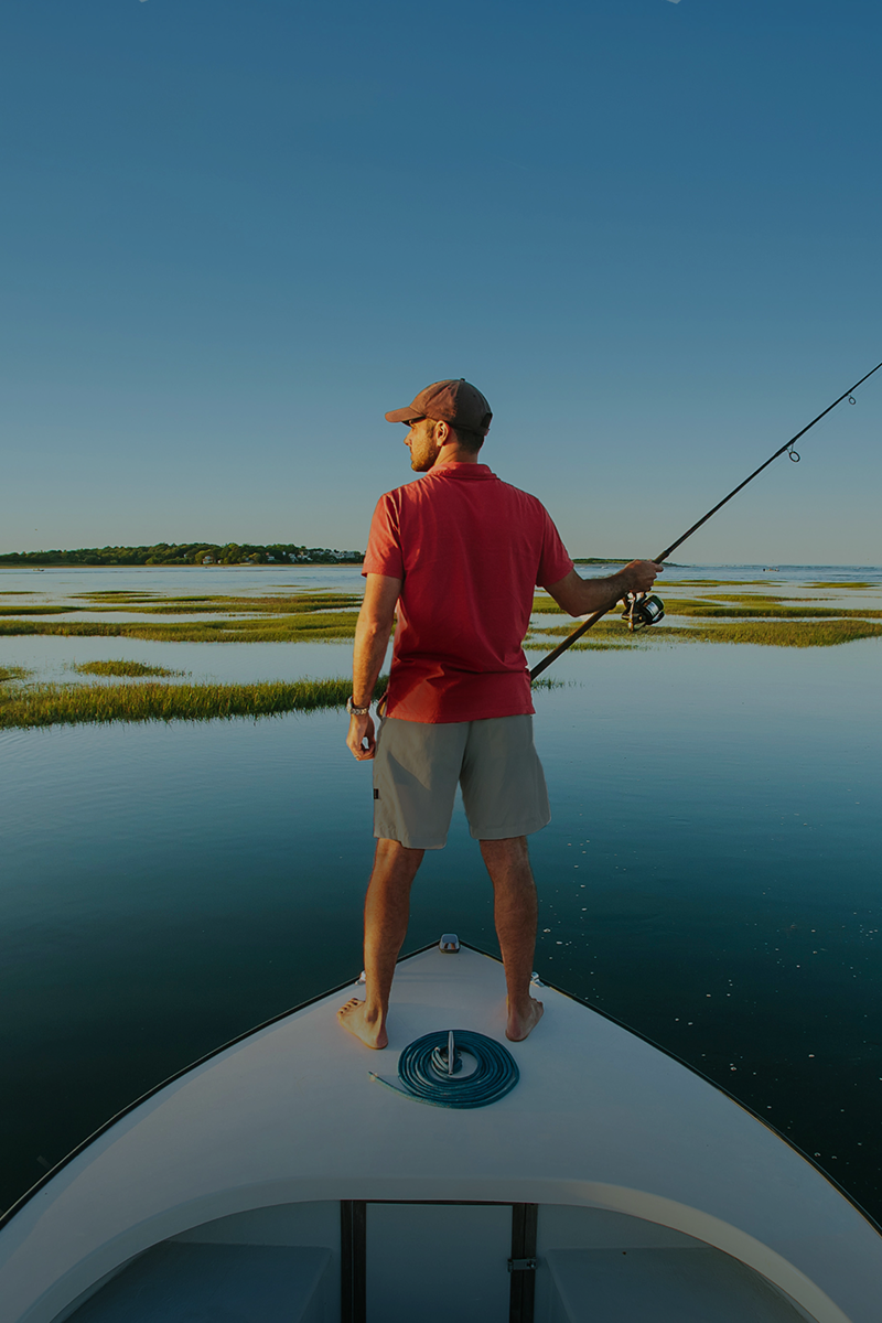 Man in a boat lookin at its left side