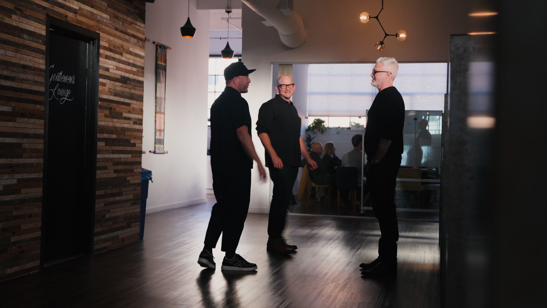 Mike, Isaac, and Marko standing in an office