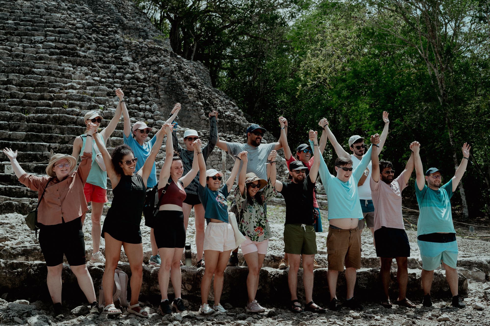 Someone team members in front of a Mayan pyramid