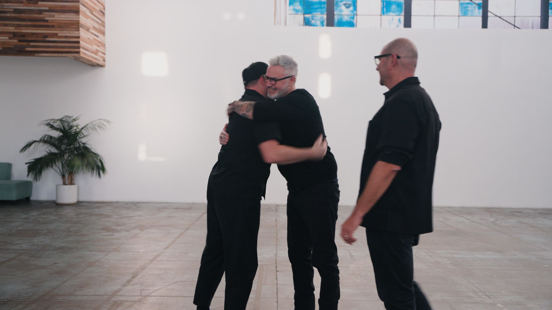 Mike and Marko hugging, and Isaac coming into the hug