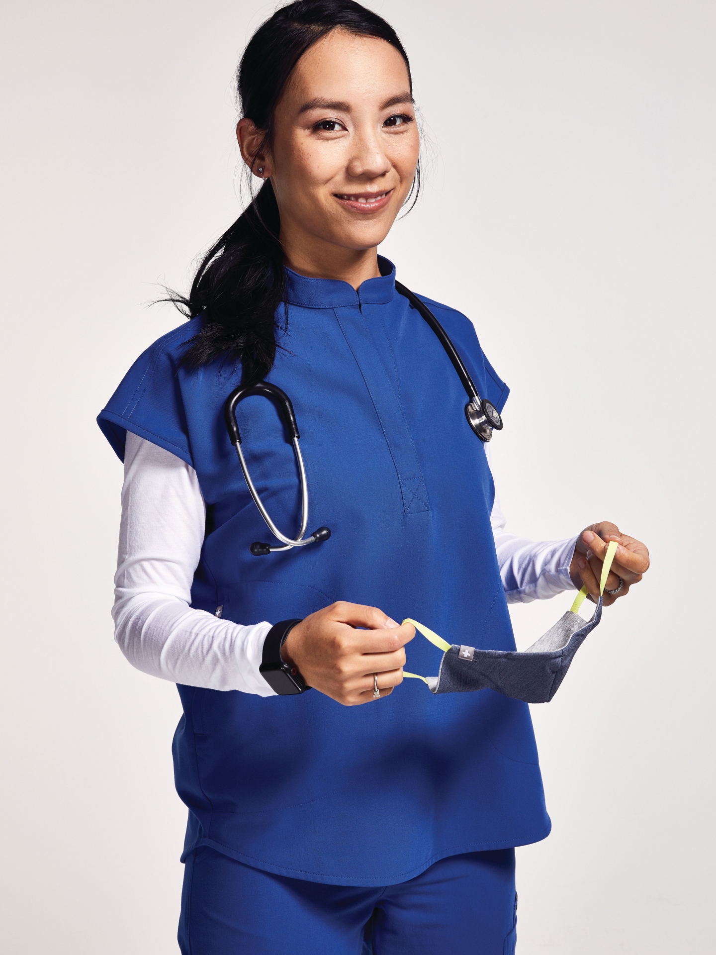 Woman posing in FIGS scrubs