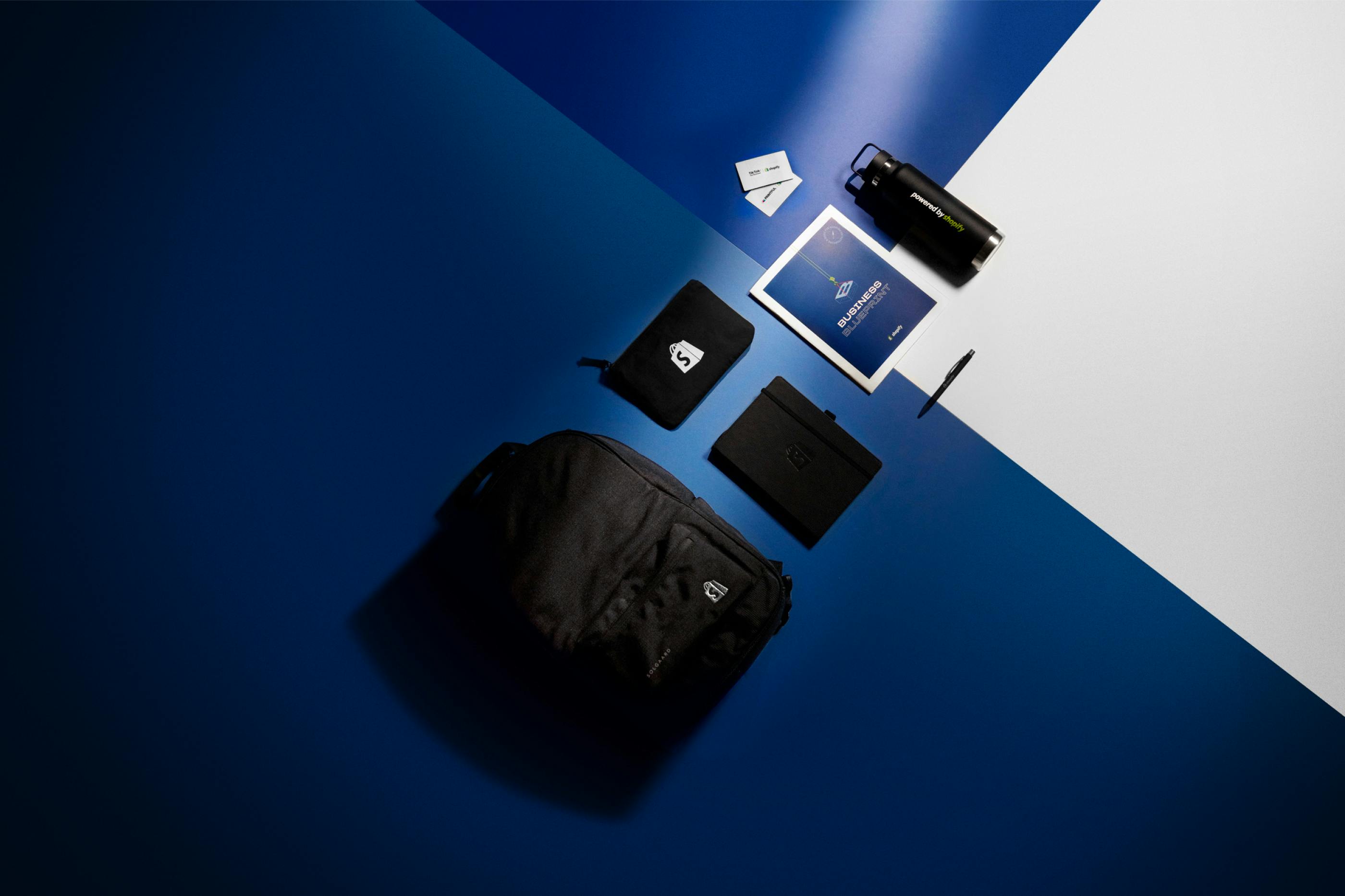 Various Shopify Supply products on blue surface
