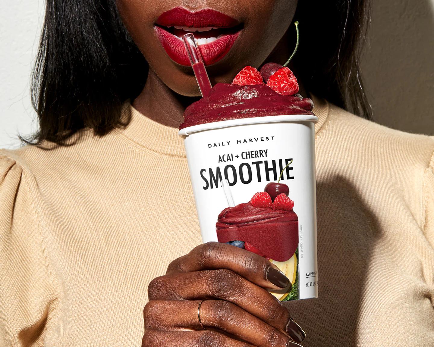 Woman sipping on Daily Harvest smoothie
