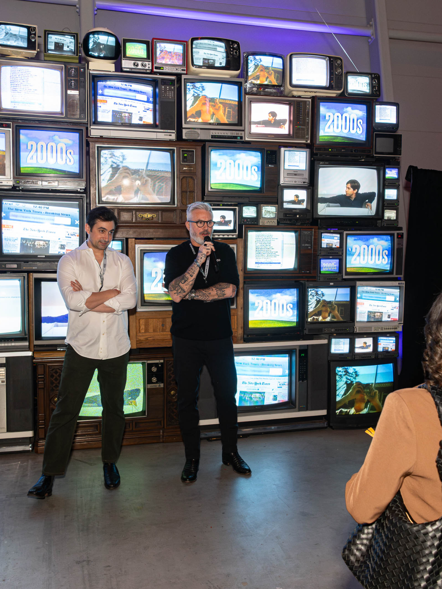 Max and Marko speaking in front of the TV wall installation at Futureshift