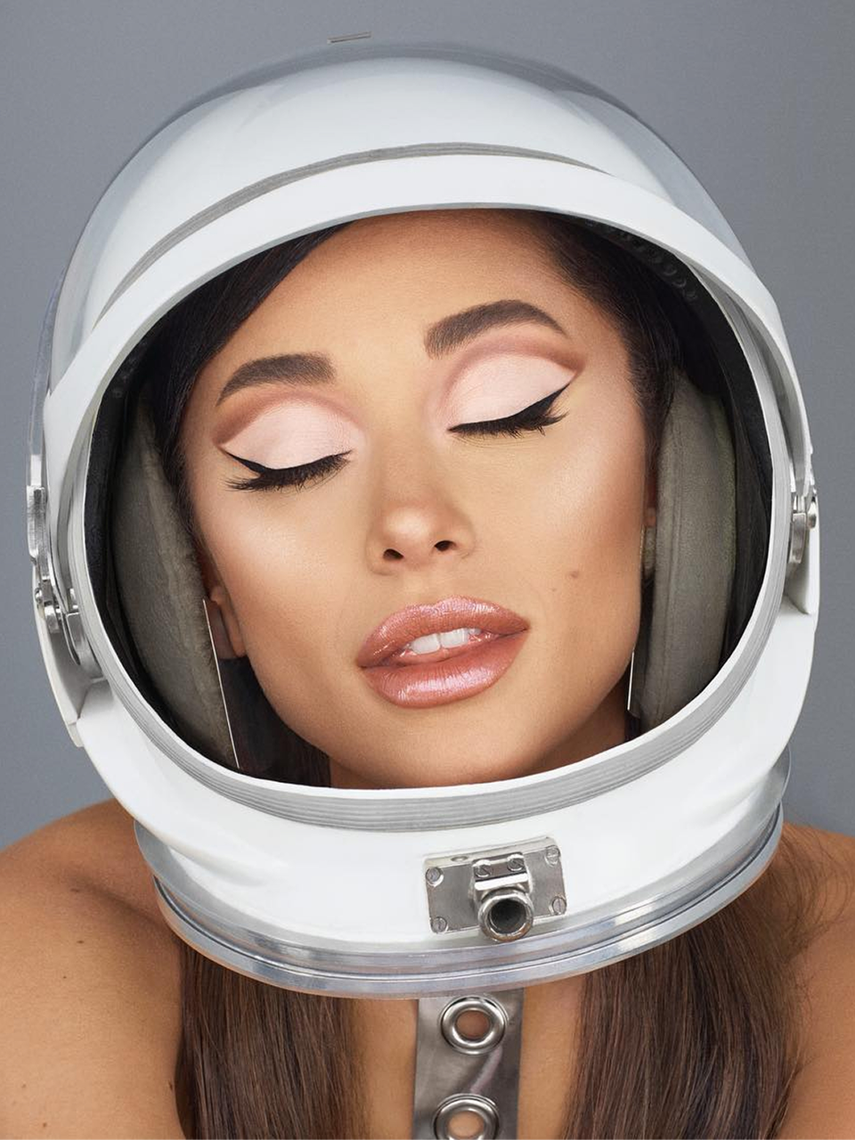 Ariana Grande wearing r.e.m. beauty products and a space helmet
