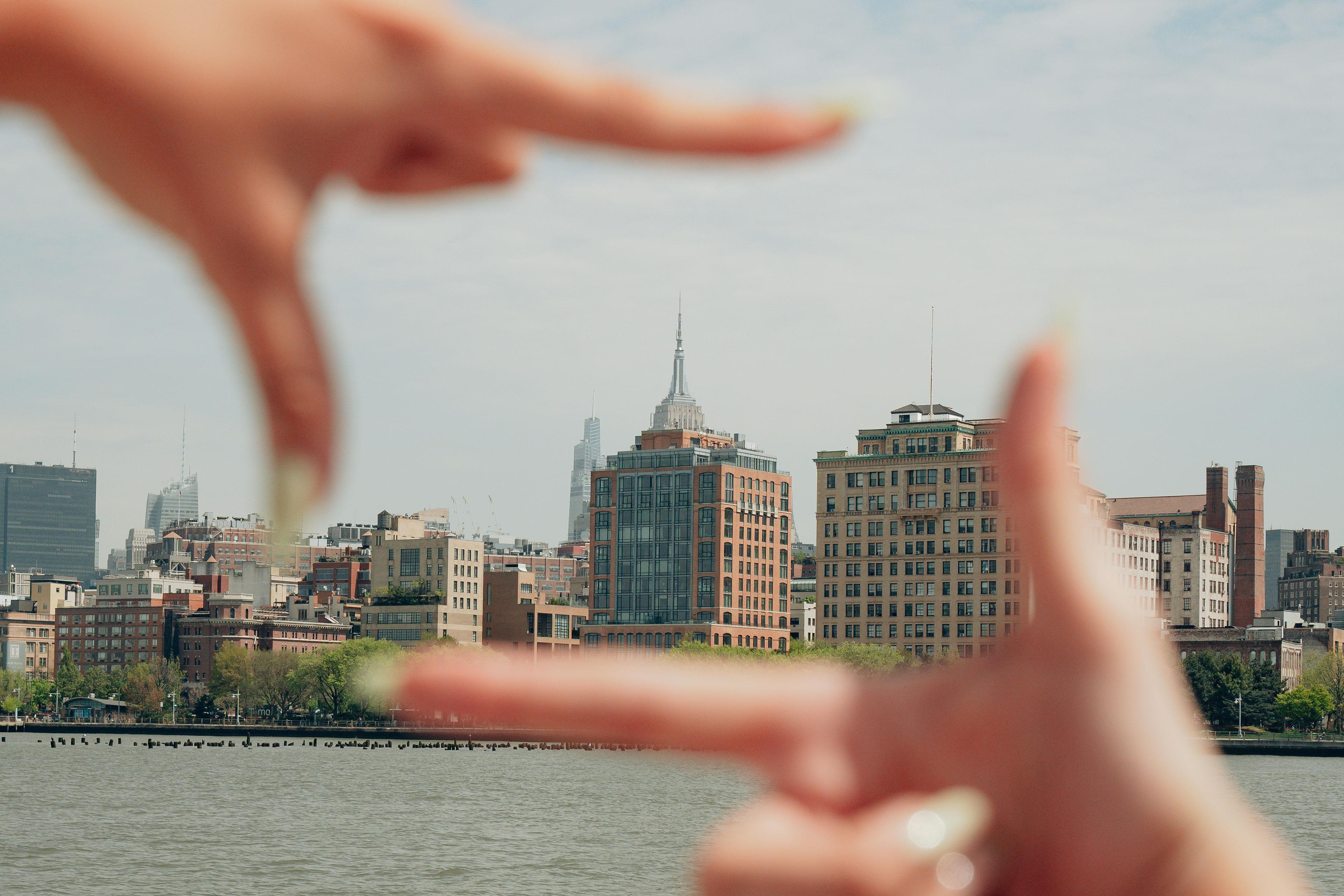 Retrospect team member using their hands to frame the NYC skyline