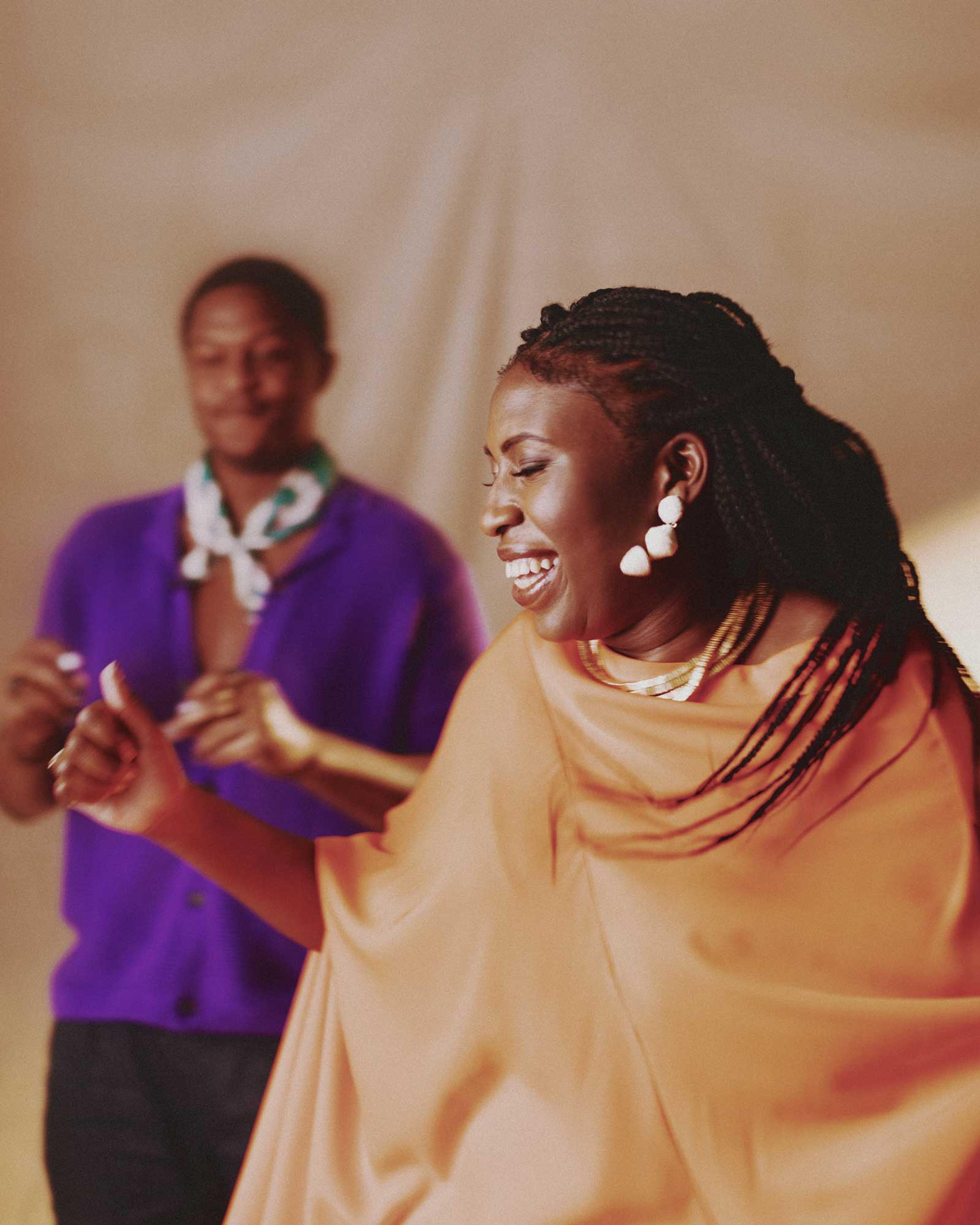 Co-Founders Joy Ekuta and Quinnton Harris dancing during a photo shoot.