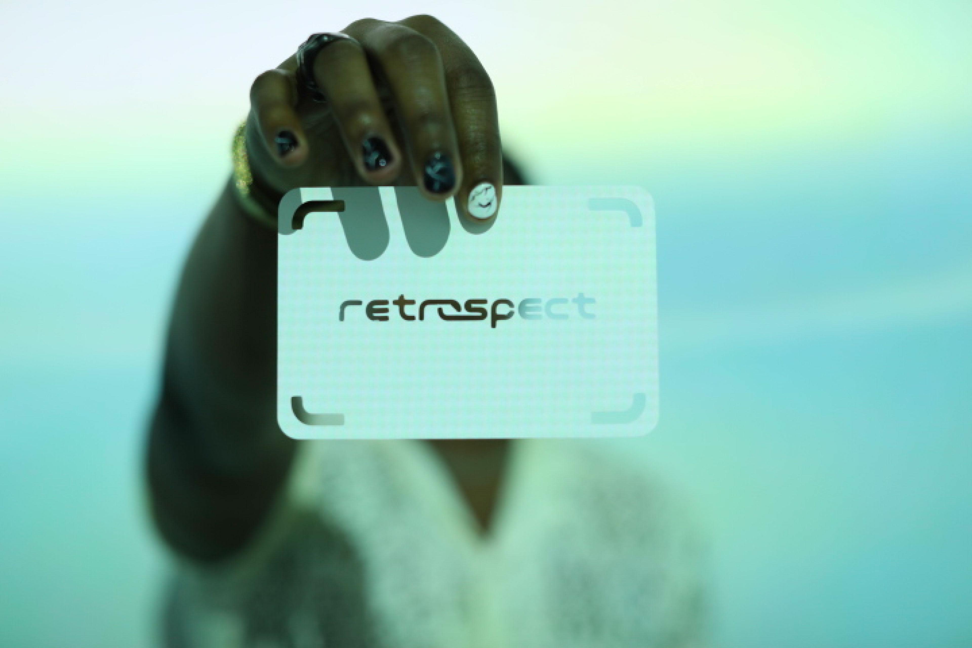 Co-founder holding cut out of the Retrospect logo