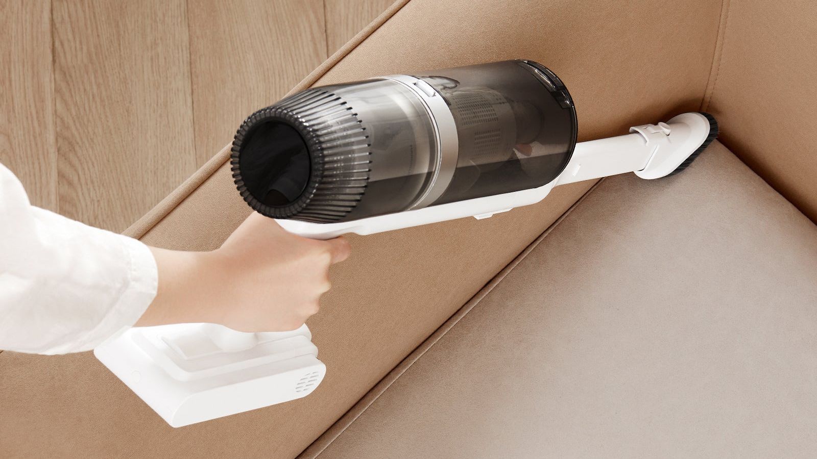 The handheld unit of the JONR VC08 Pro being used on a soft furnishing, the kind of surface where dust mites collect.