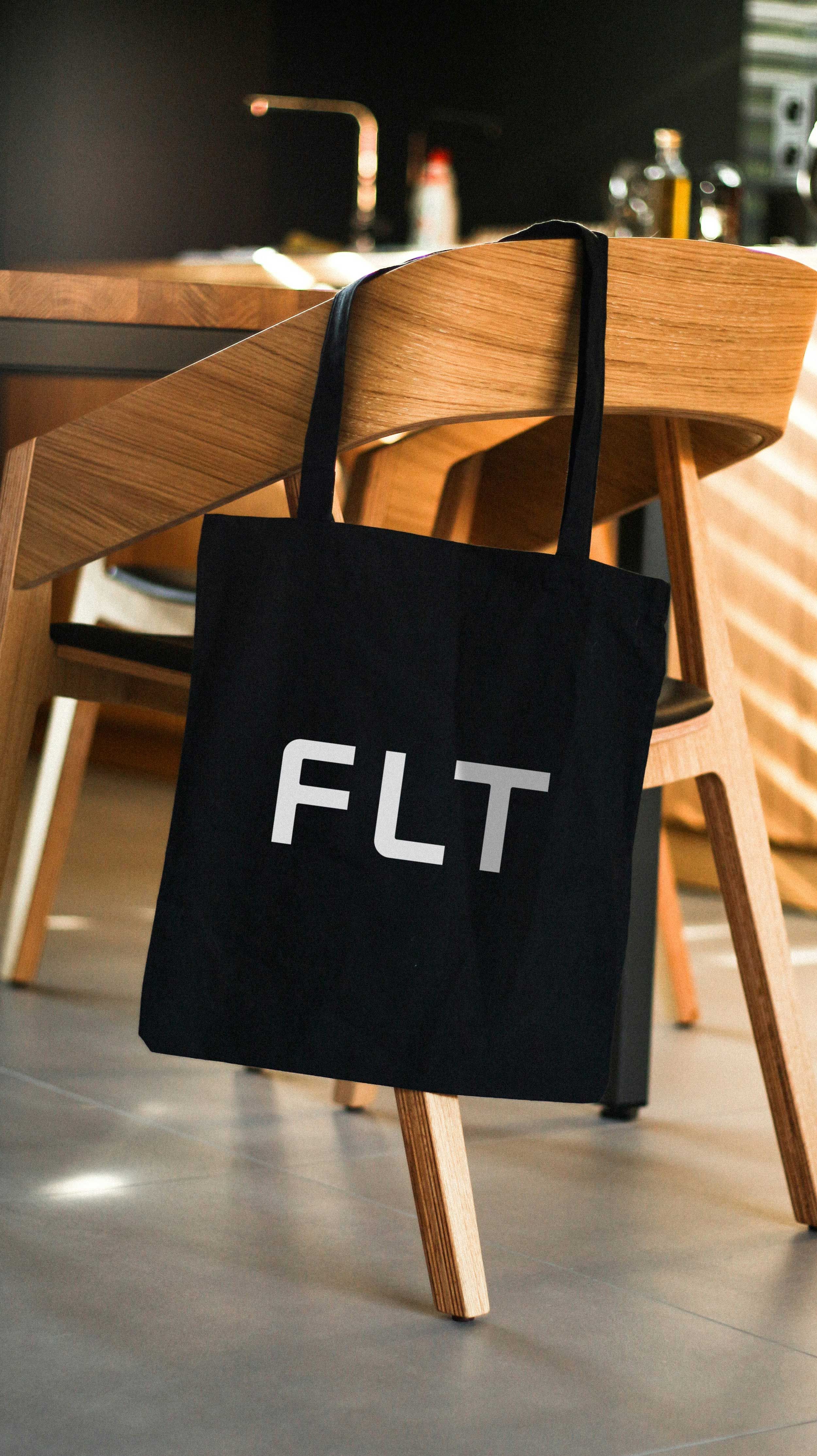 FLT tote bag mockup on chair