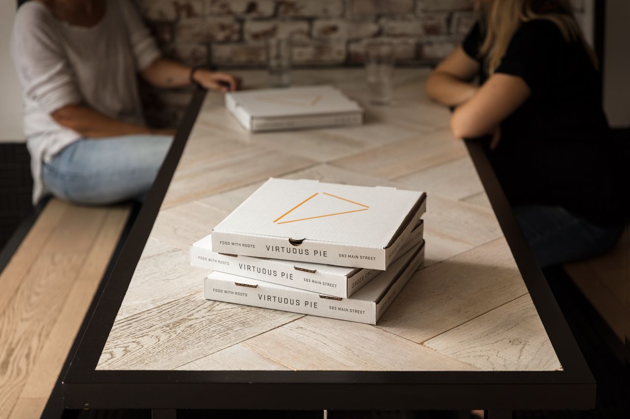 Virtuous Pie Pizza Boxes on Table