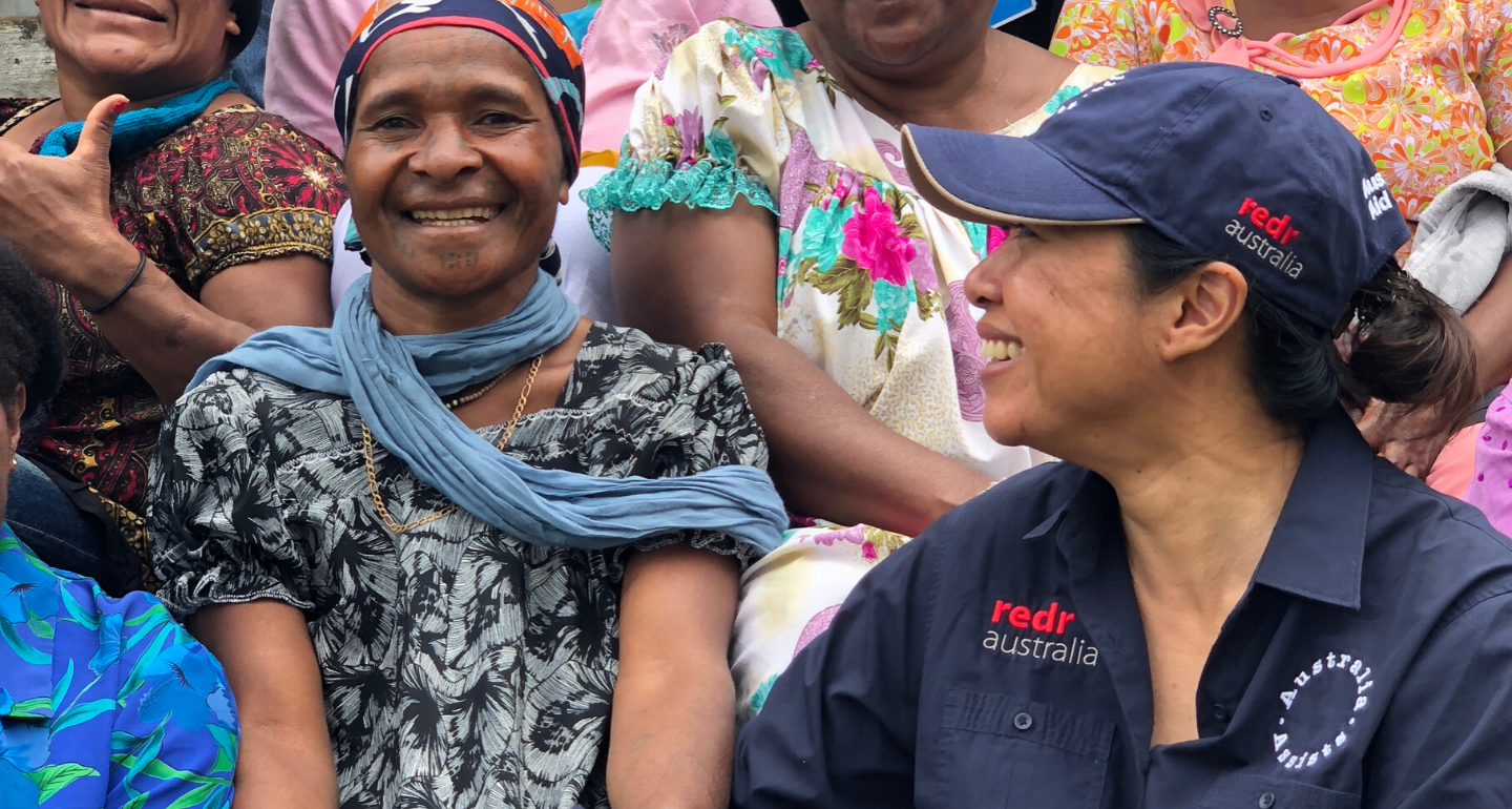 A RedR Australia specialist laughing with women from a community in Papua New Guinea