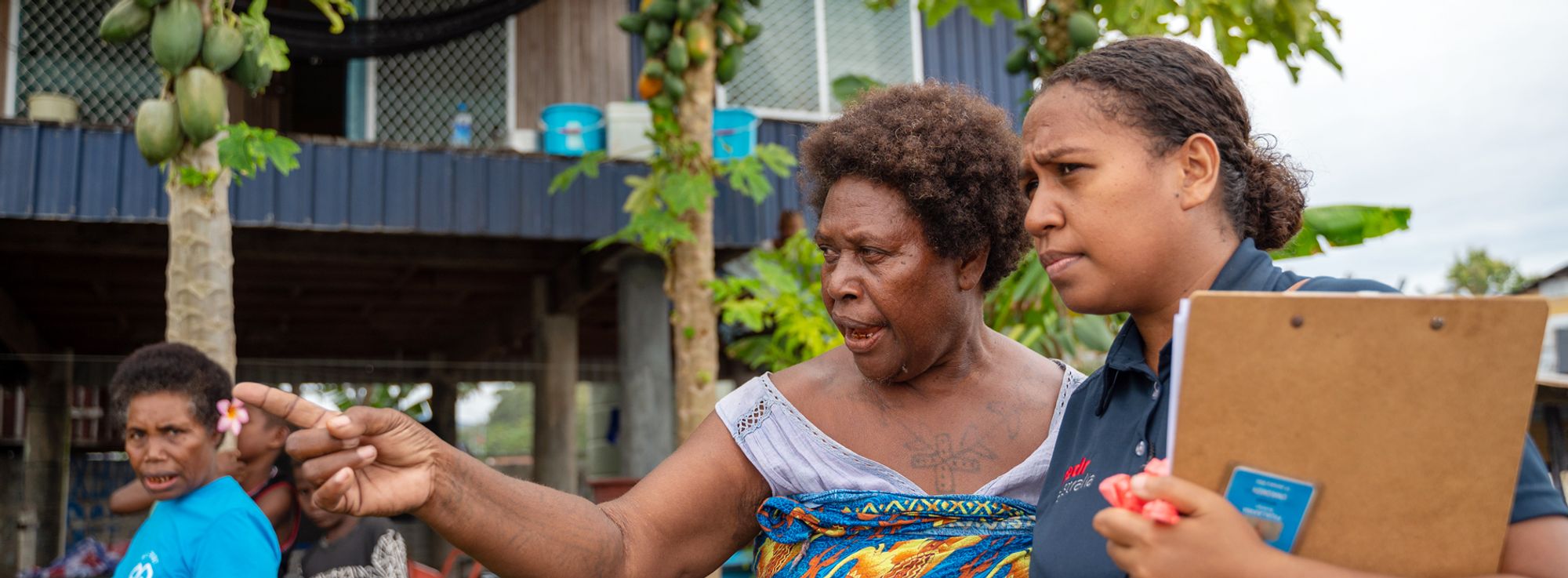 A RedR Australia specialist listening as a community member points out local conditions
