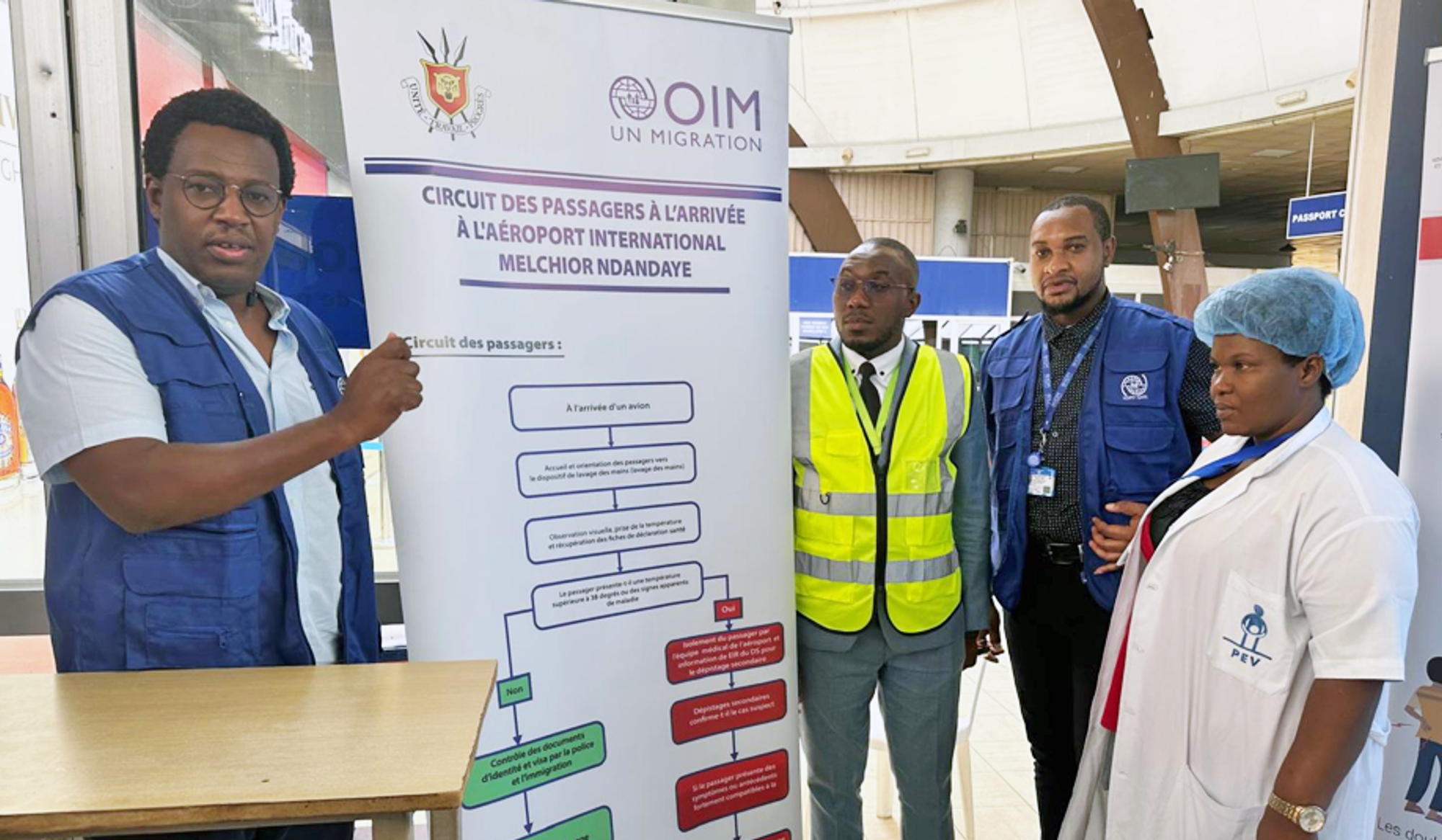 Aimé (left) is helping to strengthen disease surveillance at airports, seaports and land borders.