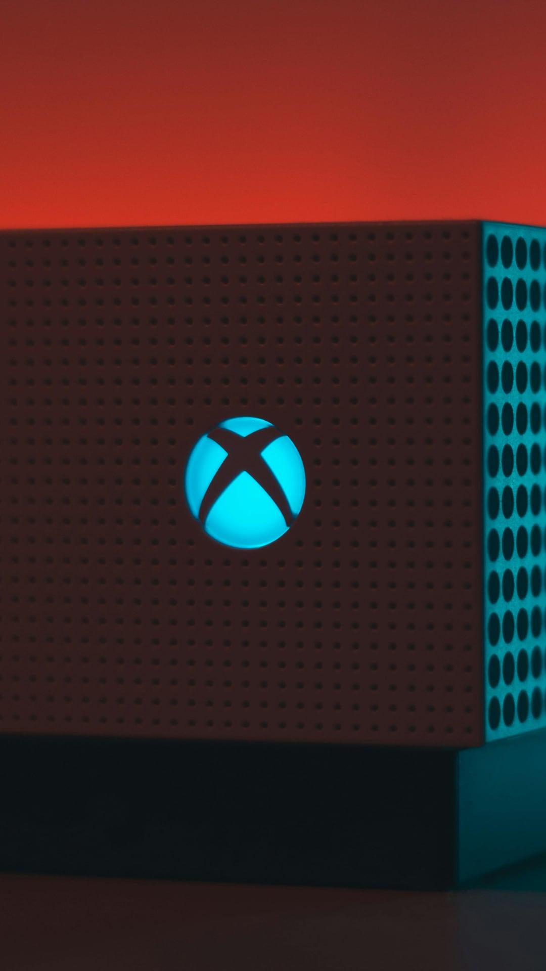 Xbox One S console with cinematic red and teal lighting