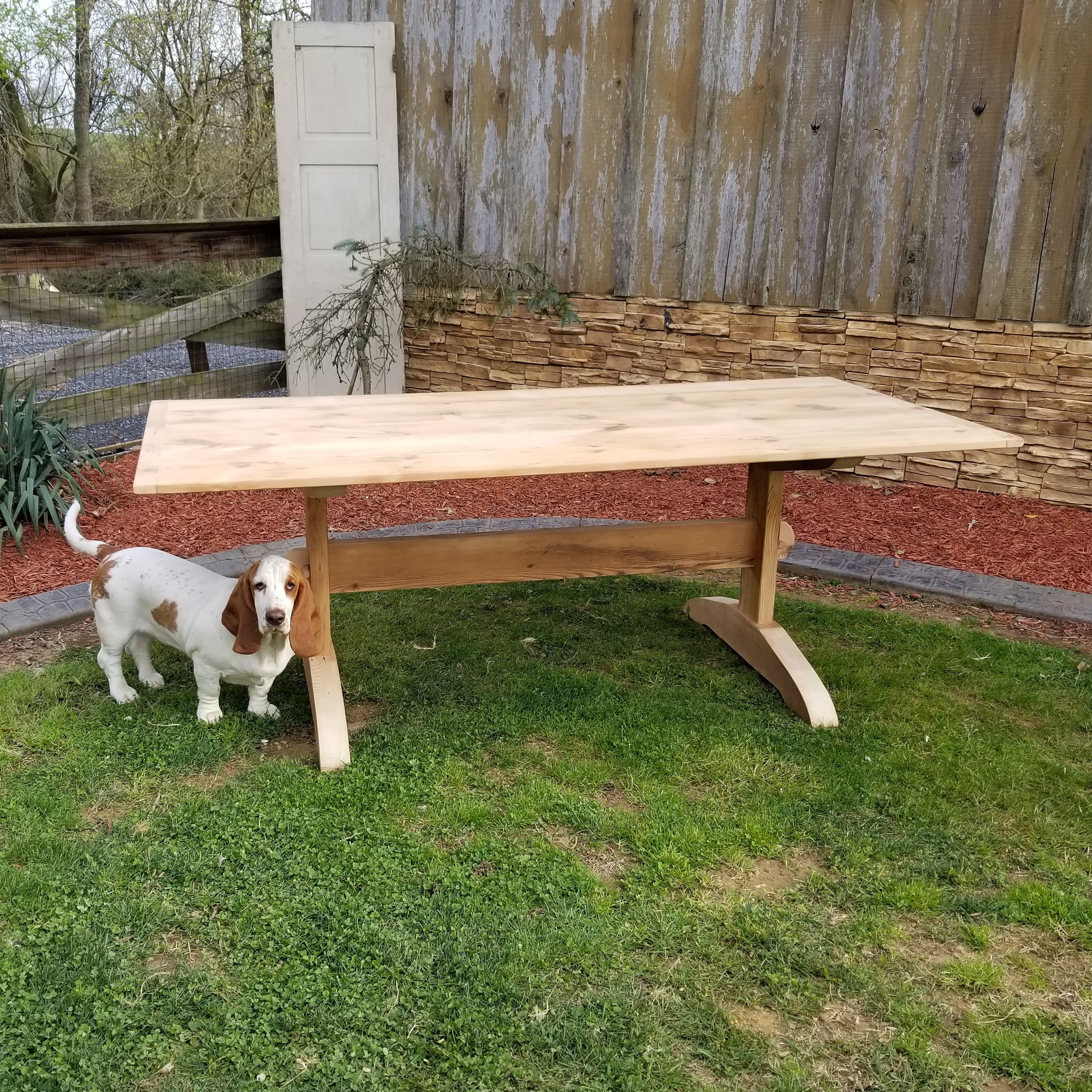 Reclaimed barnwood farmhouse table in warm window light