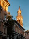 A church bell tower in Parma lit by late afternoon sun