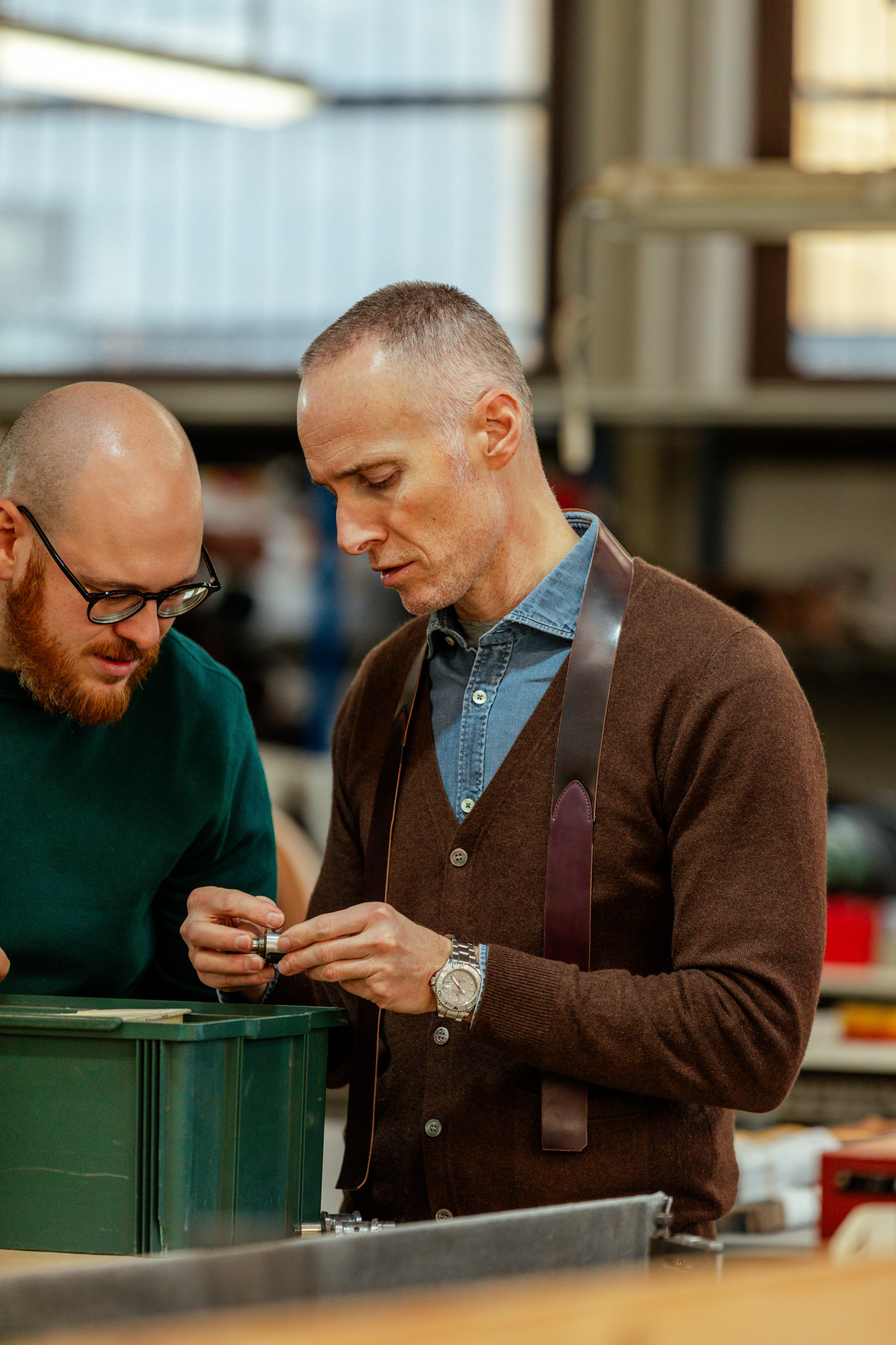 Two craftsmen examining a piece of work together in the Anderson's workshop