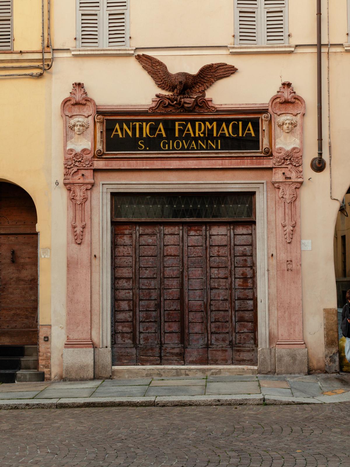 The historic facade of the Antica Farmacia San Giovanni in Parma