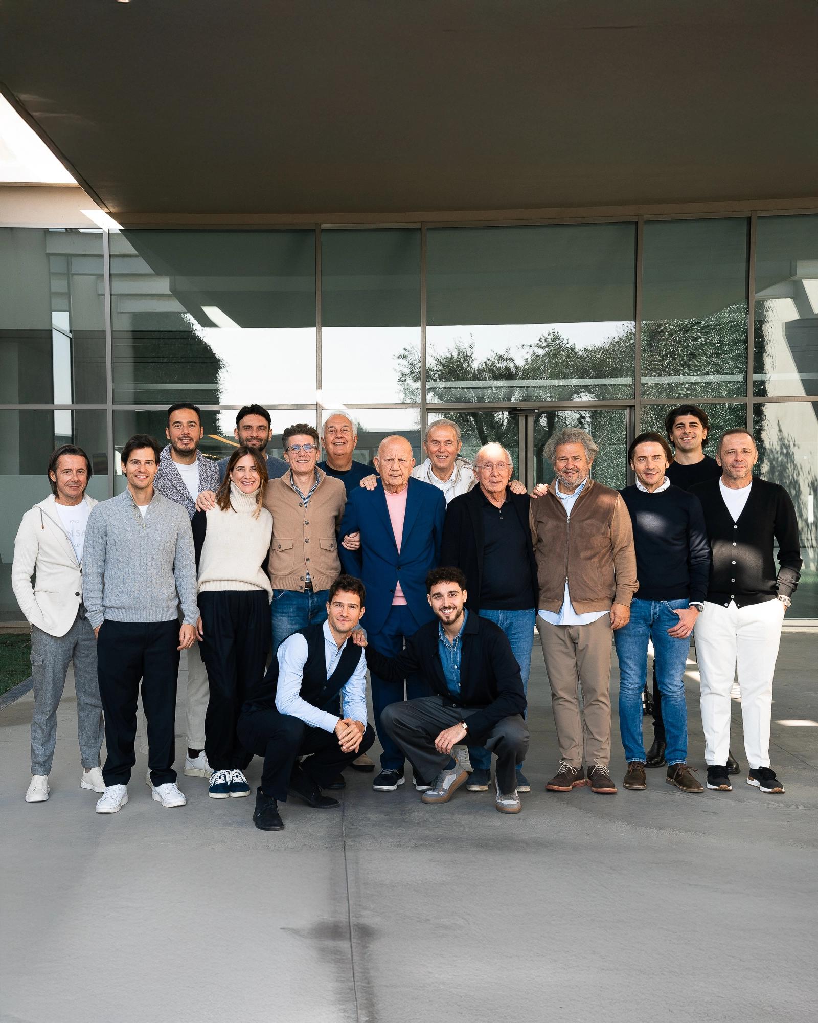 A group portrait of the Maglificio Gran Sasso team outside their factory