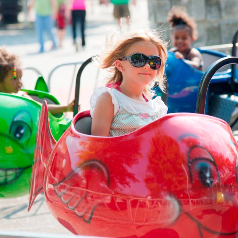 Small girl riding fish ride at DelGrosso's Park