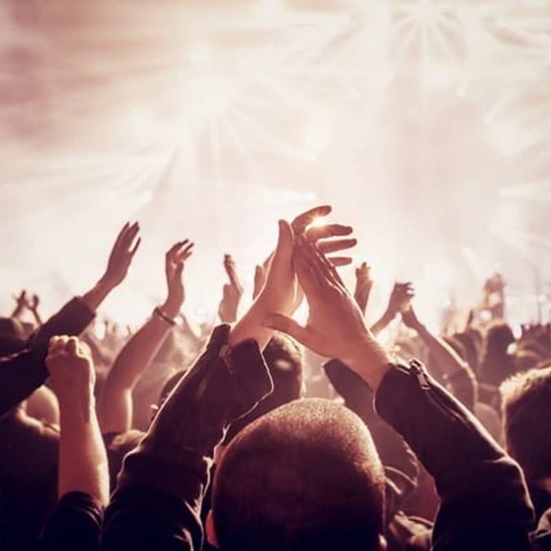 A group raising hands during worship service.