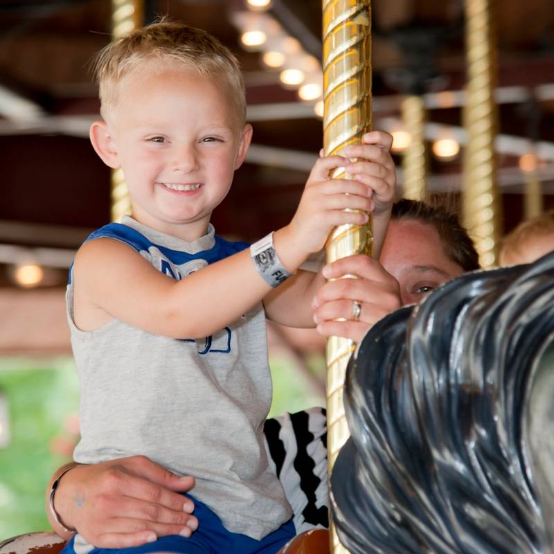 Young Boy and Dad on the Carousel Family Ride at DelGrosso's Amusement Park
