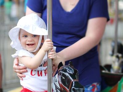 Boy riding the Kiddie Carousel at DelGrosso's Amusement Park