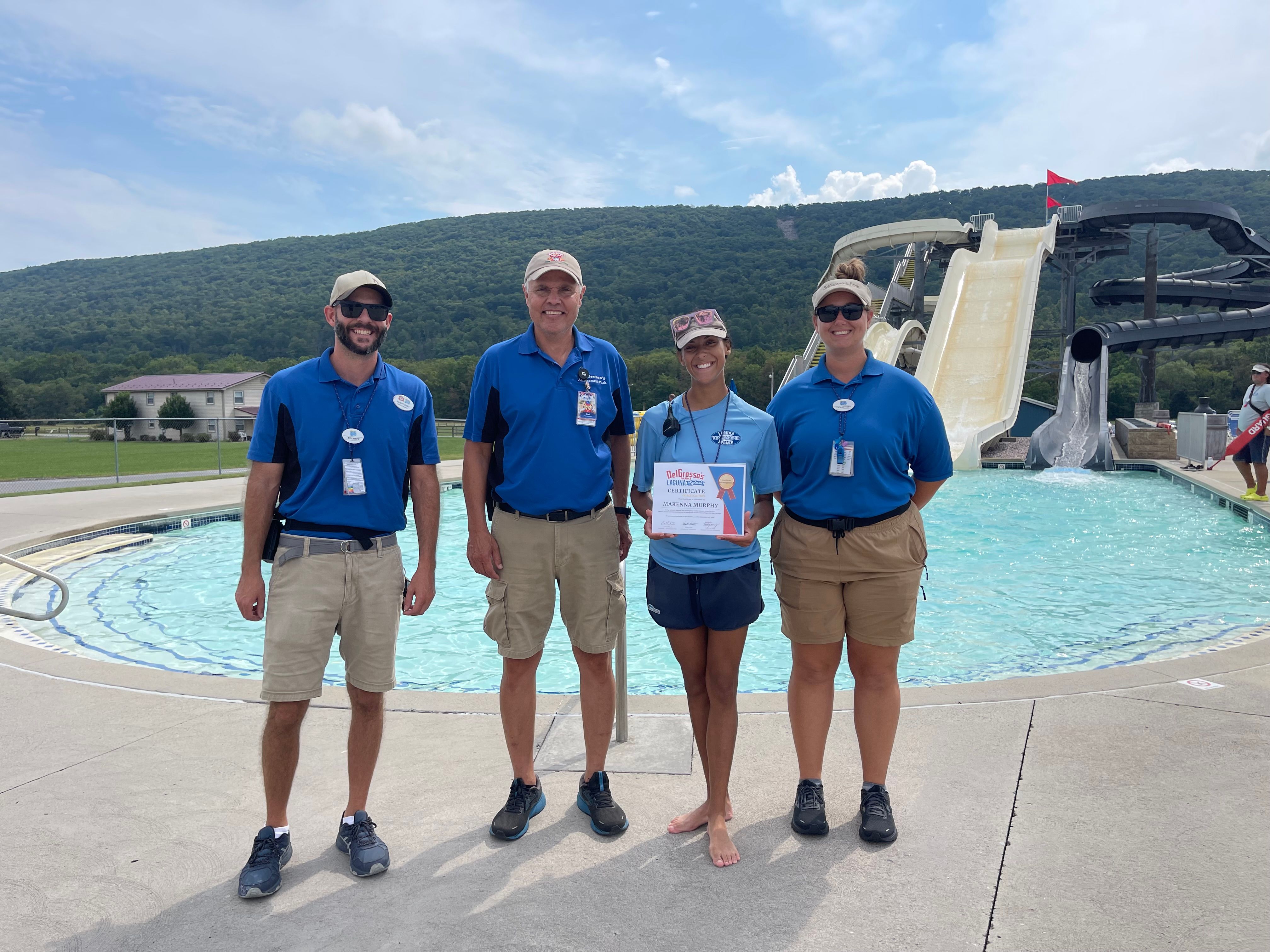 Photo with 4 people at DelGrosso's Park giving award to lifeguard at Laguna Splash