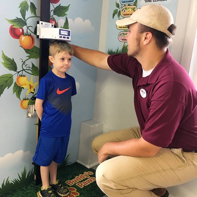 Child getting measured at Ride Height Measuring Station at DelGrosso's Park.