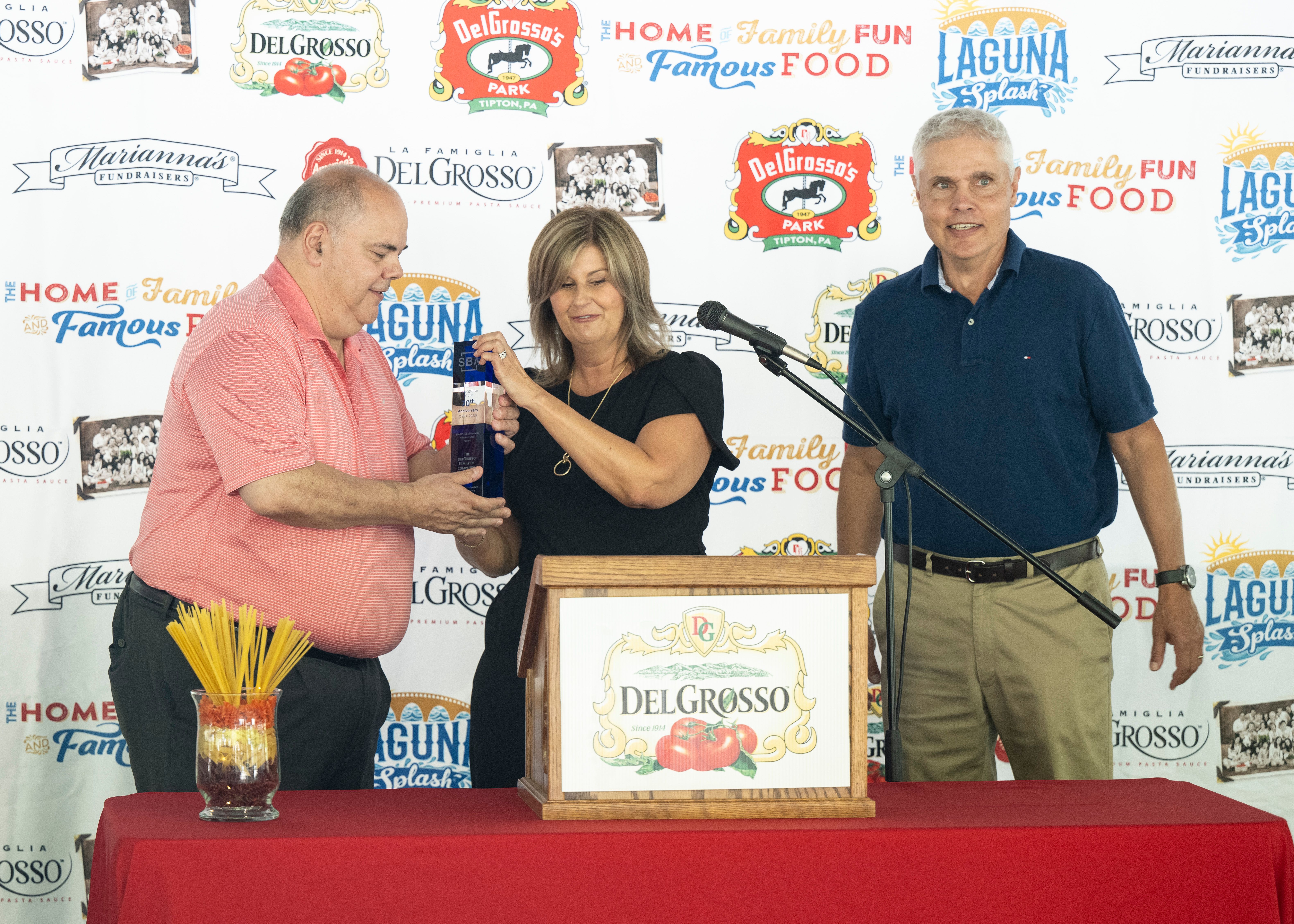 Joe DelGrosso  and Carl Crider Jr accepting an award from Dr. Kelly Hunt