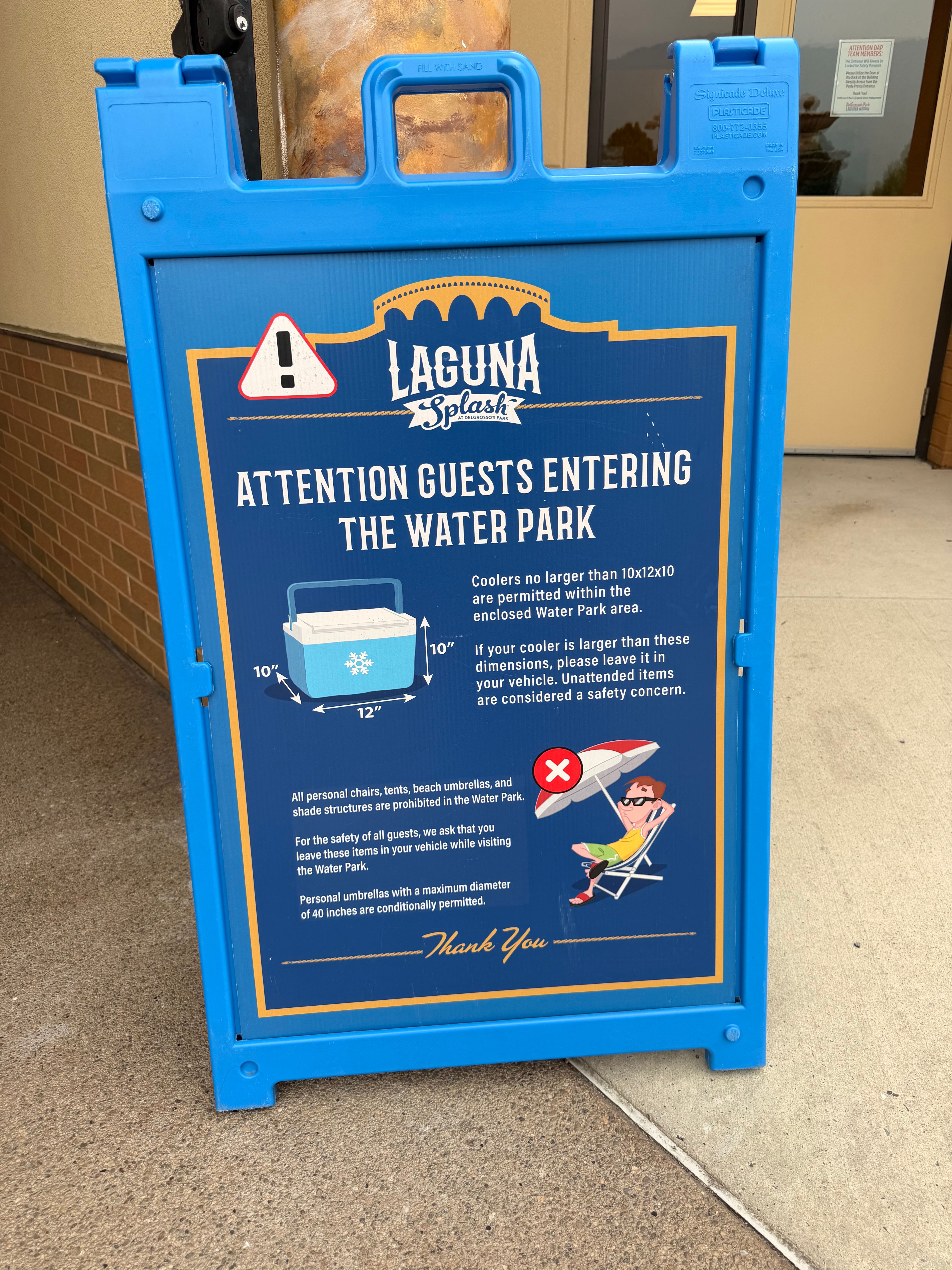 A-Frame stating Cooler Policy and noting that Beach Umbrellas, Chairs, Tents, Shade Structures not permitted.