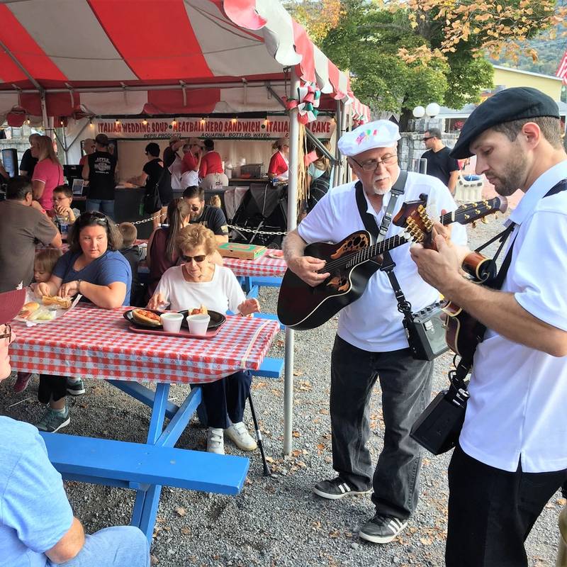 Faiella's mandolin and acoustic guitar playing for park guests.