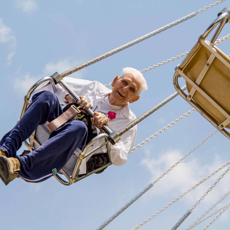 Man riding the Yo-Yo Swing Ride at DelGrosso's Park.