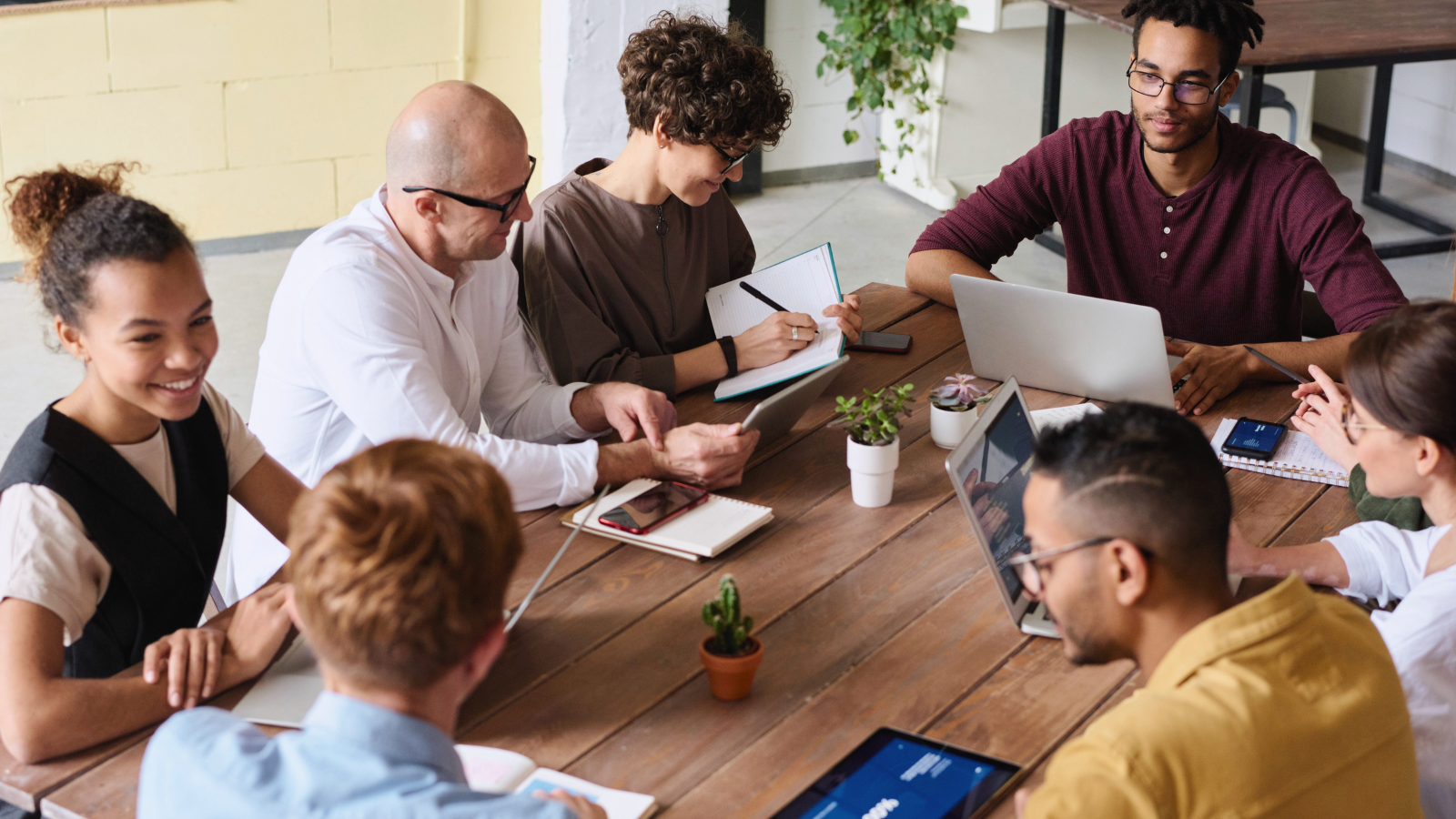 Group of coworkers having a meeting around a communal table