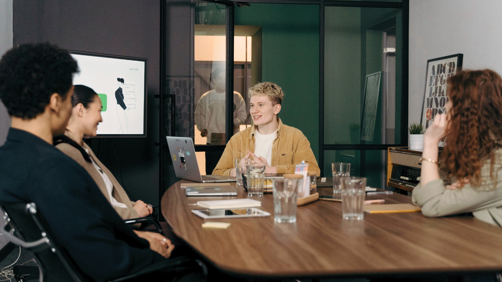Teammates in a conference room discussing a project